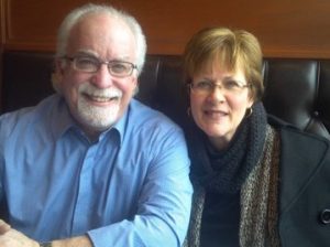 A man and woman sitting next to each other.