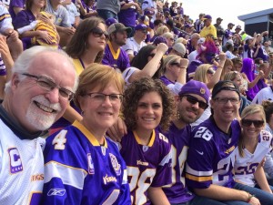 A group of people in the stands at a football game.